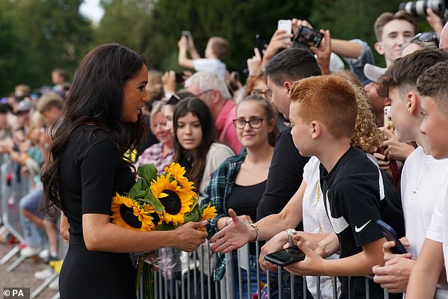 The Duchess was handed several bouquets of flowers by royal fans waiting in the crowd, but appeared eager to hold them