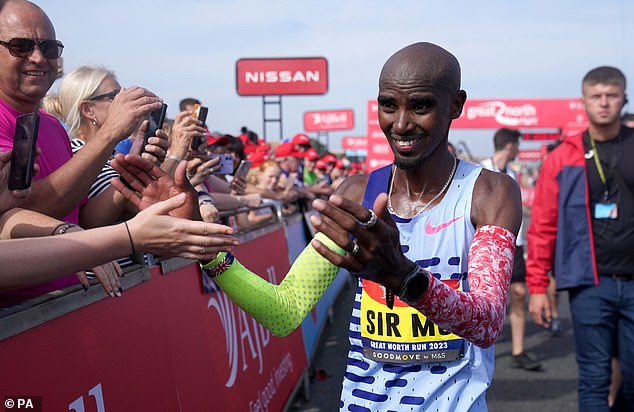 Farah was greeted by fans during the race on Sunday morning after crossing the finish line during the race