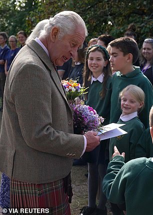 King Charles speaks to people at Crathie Kirk near Balmoral and collects bouquets and cards from schoolchildren