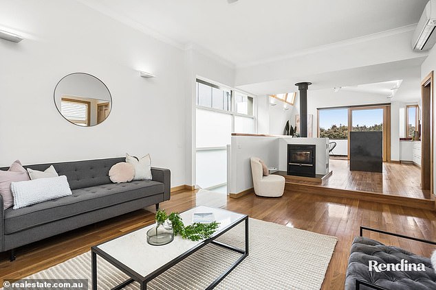 The open living and dining room has a fireplace