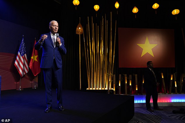 President Joe Biden took the handheld microphone and at one point left the stage to address a reporter standing at one end of the room