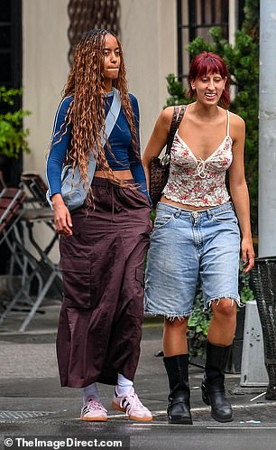 Malia's other friend paired a lace top with denim Bermuda shorts and black leather boots