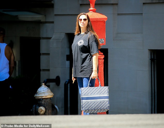 Ryan was further dressed up during Friday's outing, wearing a black FDNY t-shirt, royal blue plants and sneakers, and carrying a Christian Dior Book Tote.