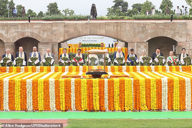 Indian Prime Minister Narendra Modi (center) joins world leaders in paying respects at the Mahatma Gandhi monument at Raj Ghat, on the sidelines of the G20 summit in New Delhi