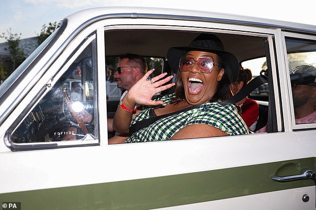 Cute: She appeared in good spirits as she toured the event and the vintage motorcycles before jumping in for a ride