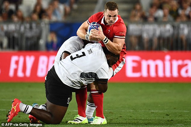 Wales' George North is tackled by Fiji's Luke Tagid during an intense battle