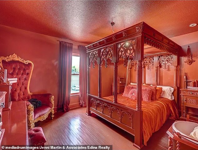 This luxurious bedroom has satin pink bedding, a suede statement chair and a luxurious sink