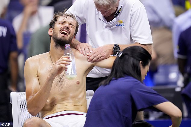 Daniil Medvedev, of Russia, reacts during a medical timeout between sets against Djokovic