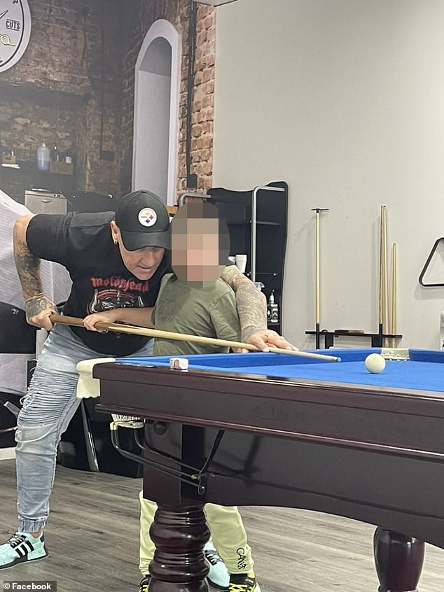 Gavin Preston teaches a young boy to play pool in an image he shared on social media