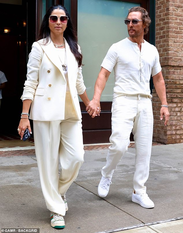 Tight: He opted for stylish comfort and wore a white short-sleeved T-shirt that was partially unbuttoned at the collar