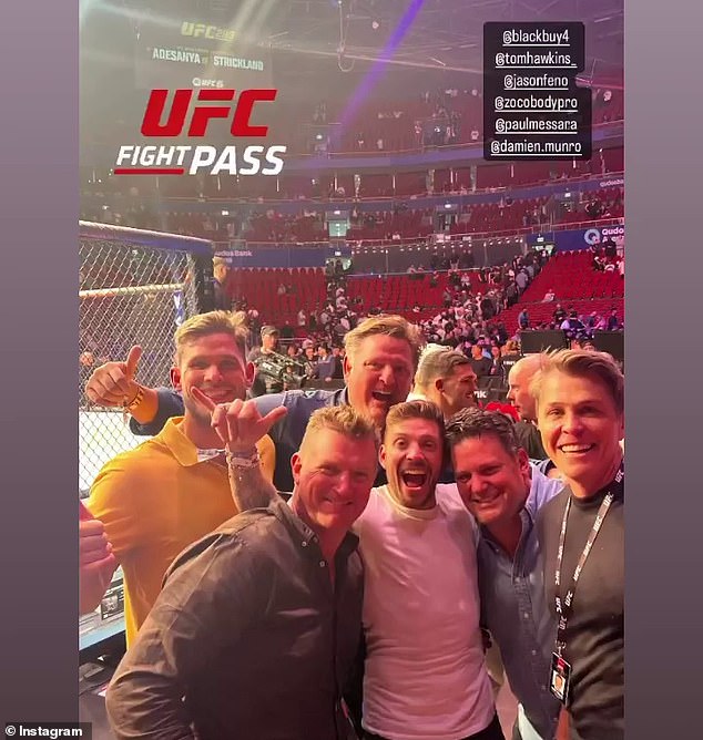 Geelong star Tom Hawkins (left) and Chris Hemsworth's trainer Luke Zocchi (second from left, front row) are pictured with friends