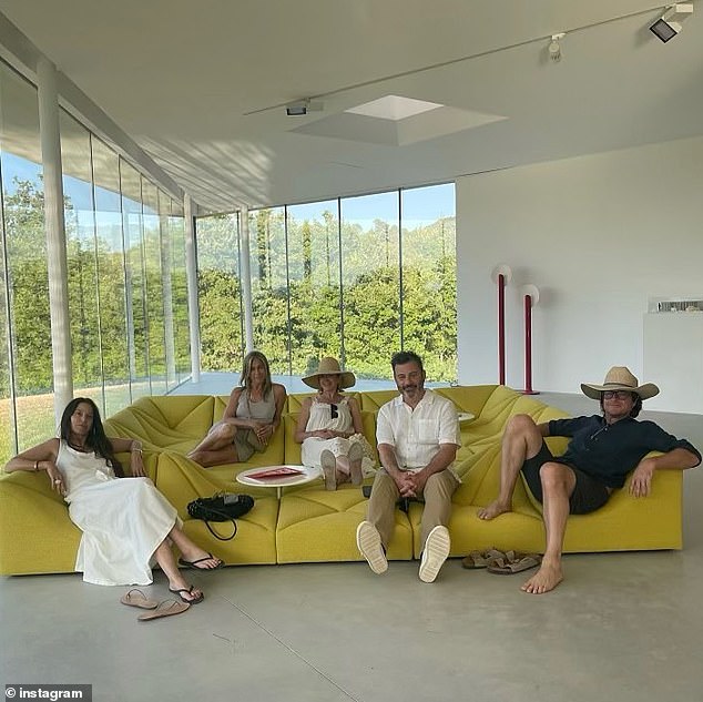 Relaxing: There was also a photo of the group relaxing indoors, sitting together on a modern yellow sofa