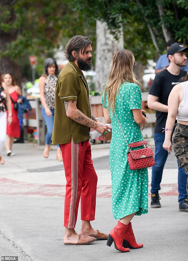 Casual: The two friends walked down the street together as Olivia looked at him with a smile