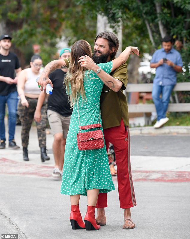 Hugs: Thune was dressed casually in ankle-length red sweatpants with white stripes on the side, which he paired with a brown short-sleeved shirt and brown slippers