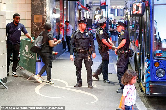 Migrants sleep outside the Roosevelt Hotel in downtown Manhattan