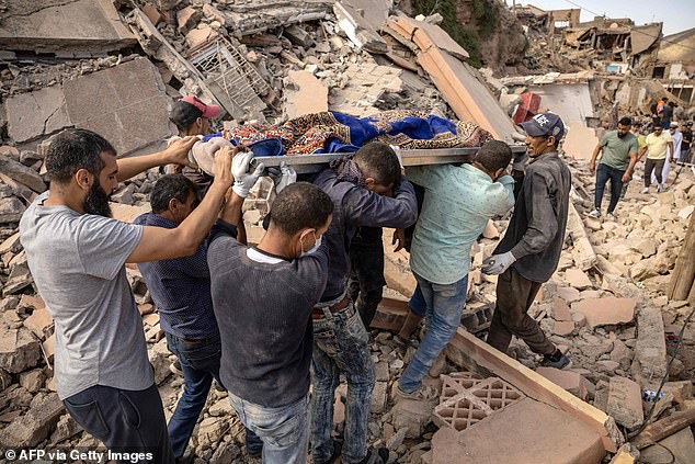 People carry the remains of a victim of the deadly magnitude 6.8 earthquake in Morocco