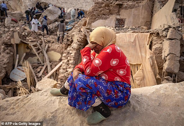 A woman is overcome with emotion at the site of collapsed buildings in Morocco, September 10