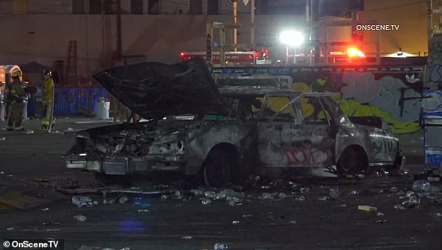 After it was set on fire, a charred car was left in the rubble