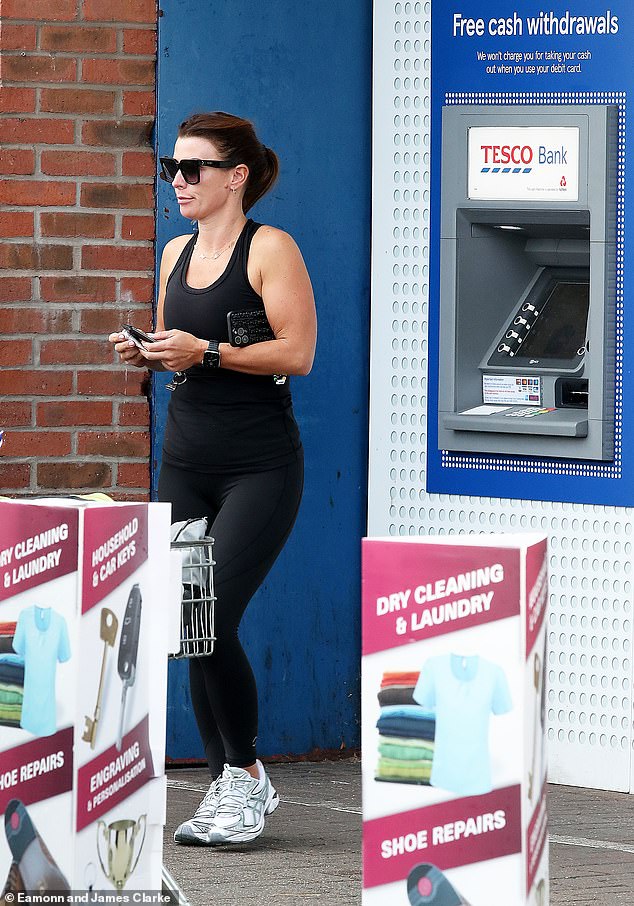 Sporty: She wore a black tank top and matching leggings, and kept it cozy with a pair of white Rebook sneakers for her quick outing