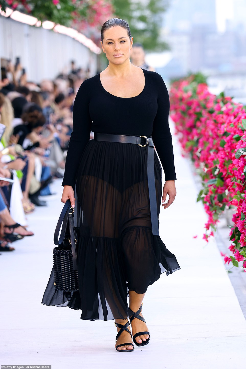 On the white runway: Ashley also wore a long black dress with sandals as she walked through the show