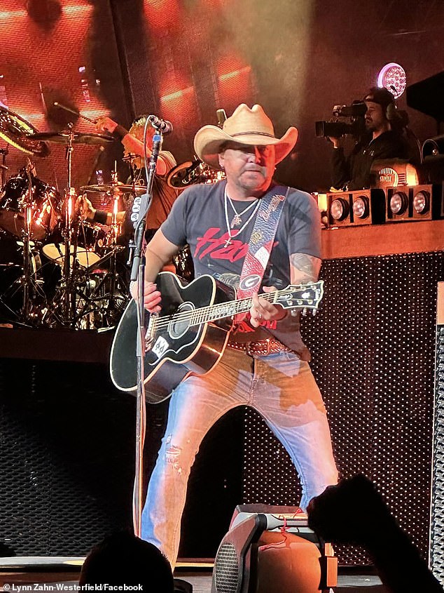 Jason Aldean is seen at a concert in Chicago on Saturday evening as a protest took place outside.  The protesters referenced his controversial song 'Try That In A Small Town' as they set fire to a flag