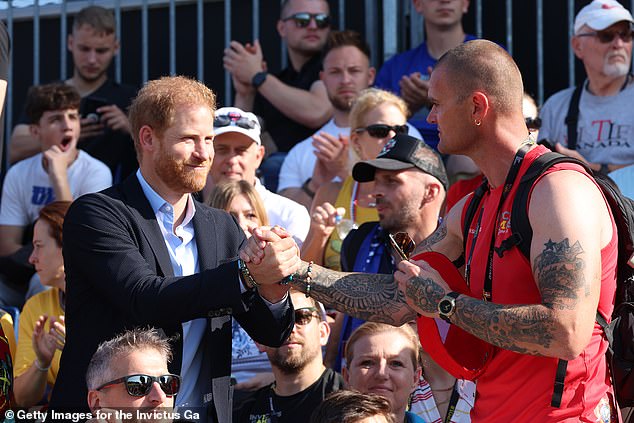 Prince Harry greets Denmark's Kasper Holm Henriksen at the athletics event today