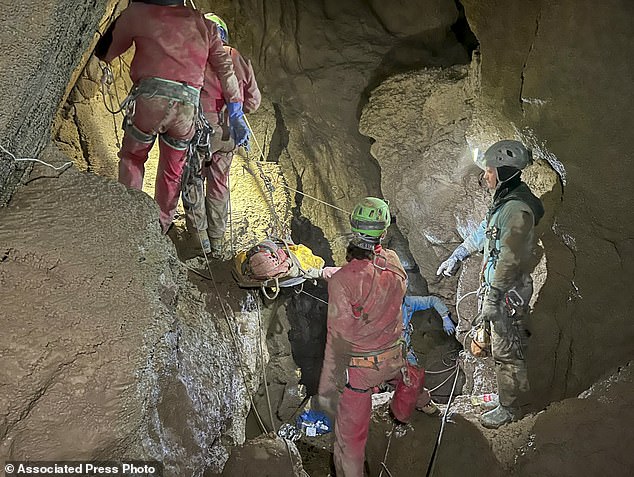 Members of the CNSAS, Italian alpine and caving rescue workers, carried a stretcher carrying Dickey earlier Monday