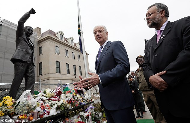 Biden is seen visiting a memorial to Nelson Mandela outside the South African embassy in December 2013.  Mandela died on December 5, 2013 at the age of 95