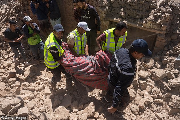 The body of a 30-year-old man is recovered from the rubble in Douzrou, Morocco on Monday