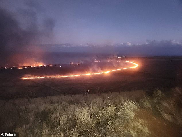 A circle of flames engulfs Lahania, Hawaii.  A devastating wildfire on August 8 destroyed the resort town, claiming approximately 3,000 structures and at least 115 lives