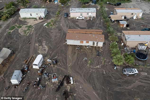 In an aerial view, mud surrounds homes damaged by a flash flood caused by a monsoon thunderstorm that quickly dropped four inches of rain in a region still recovering from Tropical Storm Hilary on September 2 in Thermal, California