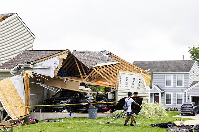 Young men help move rubble in Kent County, Michigan, in August after at least four tornadoes touched down in Michigan, driven by gusts of wind, killing several people