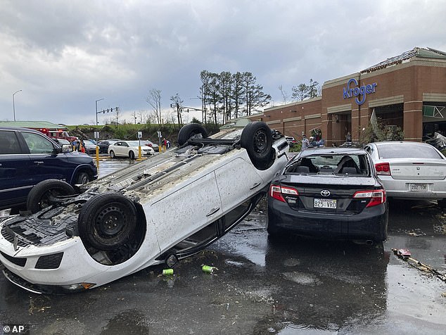 A car sits upside down in a Kroger parking lot after a severe storm blew through Little Rock, Arkansas on March 31