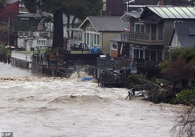 Wharves along Soquel Creek in Capitola Village are inundated by a storm surge on January 5 in Capitola, California