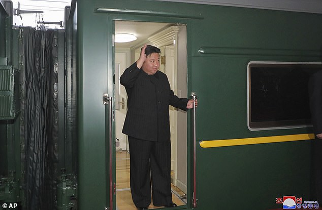 Kim Jong Un waves from a train in Pyongyang, North Korea, before leaving for Russia on Sunday