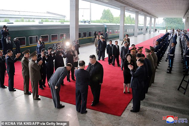 Pictured: North Korean leader Kim Jong Un (C) is sent on the red carpet as he departs Pyongyang by train for a visit to Russia on Sunday.  He arrived in Russia on Tuesday