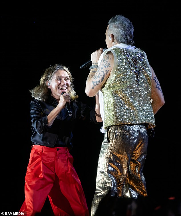 Reunited: During a performance at Sandringham House in Norfolk, the 49-year-old singer surprised 20,000 fans by bringing Mark, 49, on stage