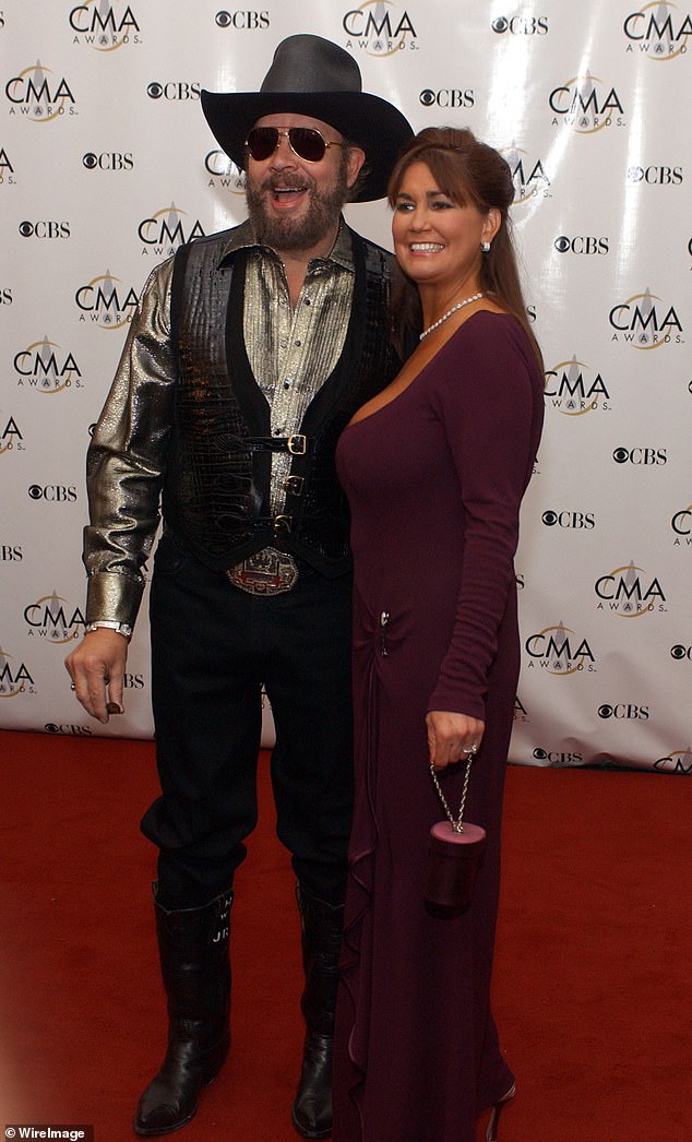 Tragic: Mary died of a collapsed lung just a day after having liposuction and breast implant removal (pictured together at the 37th Annual CMA Awards in Nashville in 2003)