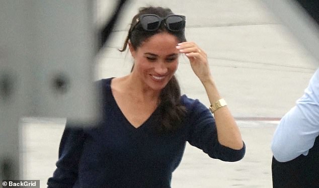 On her wrist, Meghan wore a yellow gold Cartier Tank Francaise watch, worth a whopping $26,000