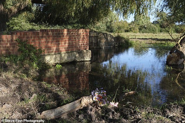 Shockingly, flowers were left at the remote spot.  Phil's parents, David, 89, and Anne, 82, who both died after their car went over a bridge and ended up upside down in a river