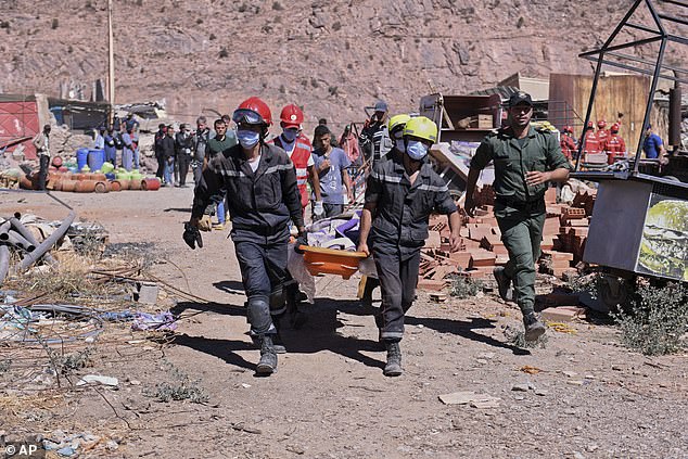 A victim is taken away by rescuers in Talat N'yakoub, Morocco