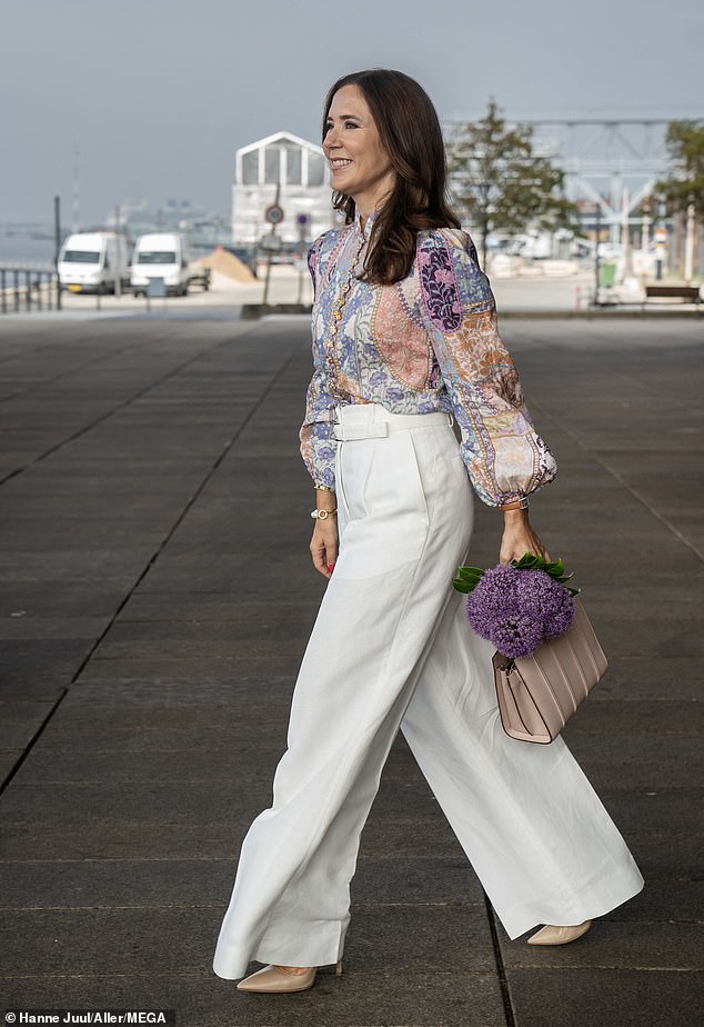 The mother-of-four, 51, wowed in chic white trousers which she teamed with a pastel floral blouse on Monday