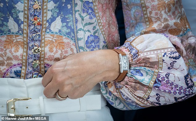 The royal family looked elegant in the beautiful blouse with beautiful brooch style buttons