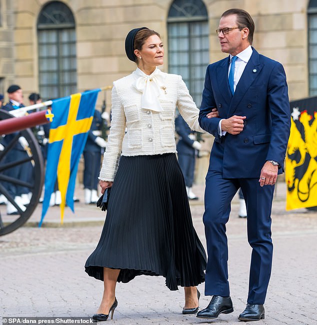 With the Swedish national flag flying behind them, the couple strode arm in arm across the cobblestones of the cathedral