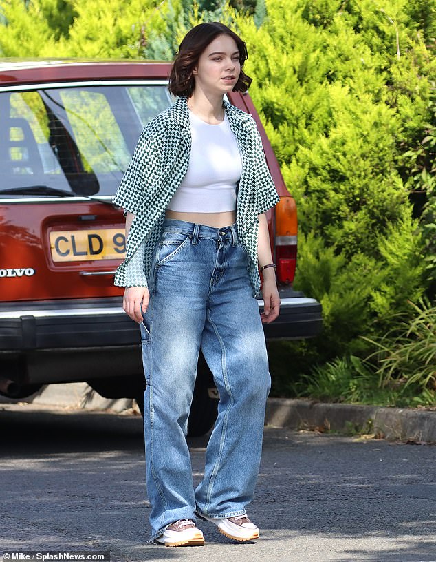 Toned: Wednesday star Emma Myers, 21, showed off her graceful midriff in a white crop top and jeans