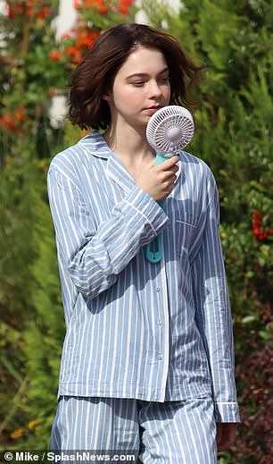 Scorcher: Emma was then seen in pajamas, cooling herself with a hand fan