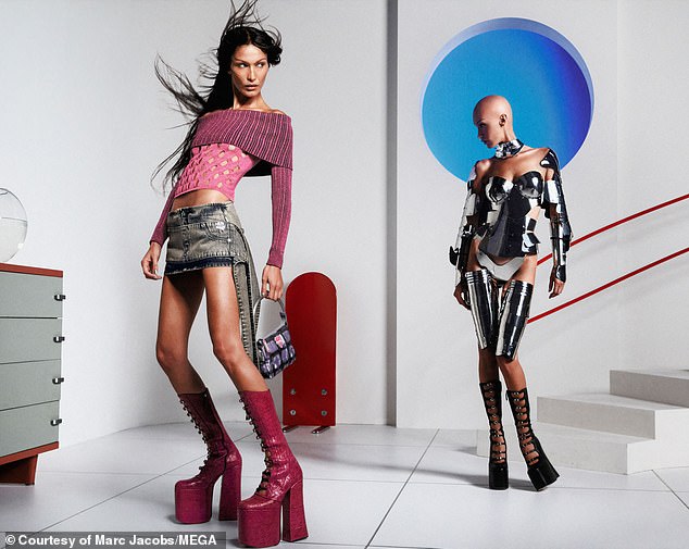Wow!  Bella also posed in the brand's Kiki boots, along with a mini denim skirt and pink top, with her robot counterpart behind her.