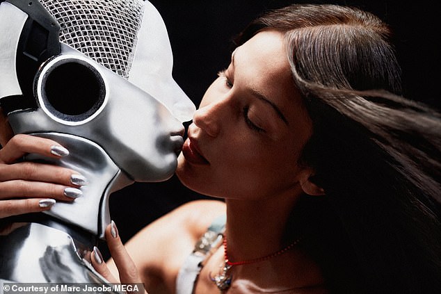 In love: The beauty wore silver metallic nails as she got close to her robot friend