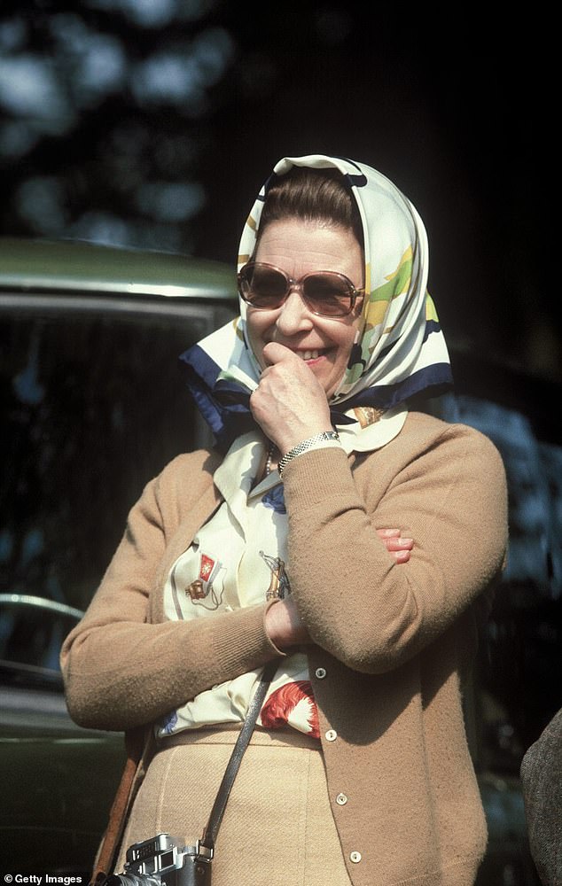 The Duchess of Sussex, 42, carried the £1,000 Hermes Brides gala scarf in her bag as she boarded a plane in Los Angeles to take her to Dusseldorf for the Invictus Games.  The Queen is pictured wearing the same scarf in 1982