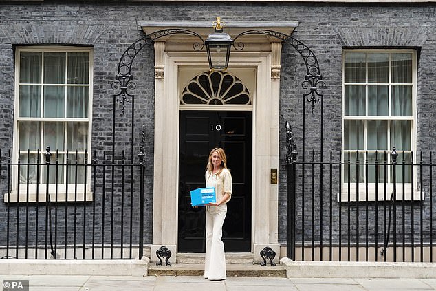 Chic: The TV presenter, 46, looked elegant in a cream-coloured silk blouse paired with white flared trousers